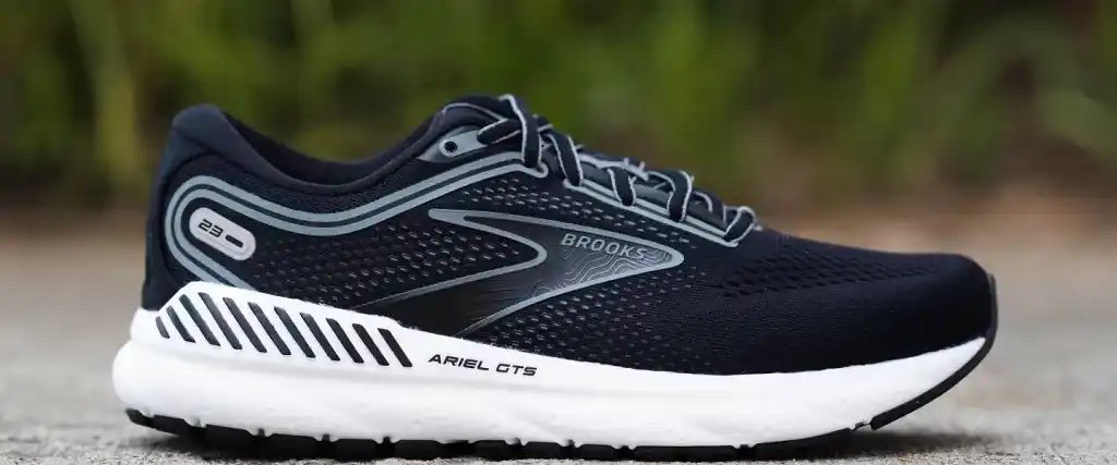 A side view of a black and white Brooks Ariel GTS Best Running shoe