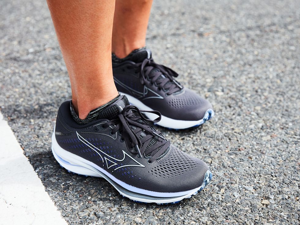 A view of a person black sneakers on a roady surface