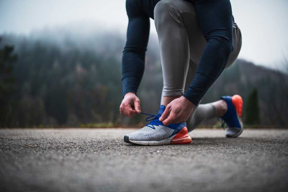 A view of a person tying laces of thier new balance shoes