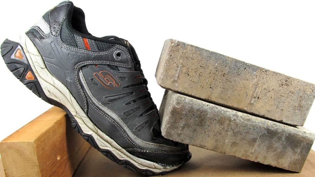 A view of bricks putting weight for holding a sneaker together for glue fixing