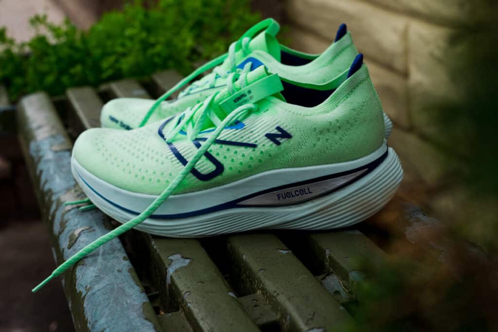 A view of green New Balance SuperComp Elite Running Shoes sitting on a bench