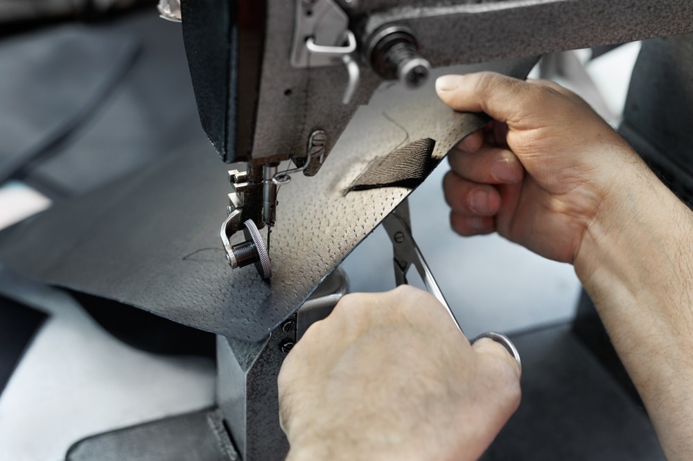 Sewing Machine In The Leather Workshop Is In Action Hands